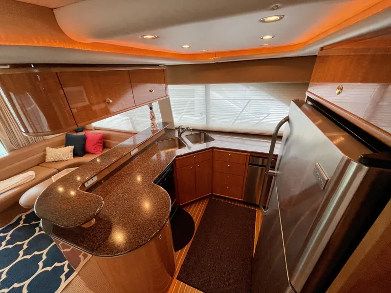 Slide: The Image of Luxurious kitchen area in a 2002 Bayliner 5788 yacht with modern appliances and elegant design. - 18