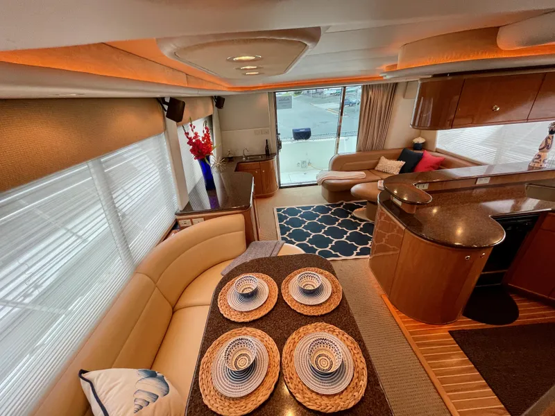 Slide: The Image of Luxurious interior of 2002 Bayliner 5788 yacht with modern decor and dining setup. - 24