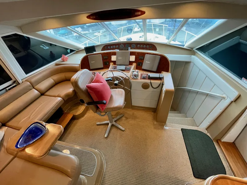Slide: The Image of 2002 Bayliner 5788 helm with electronic Cummins QSMs, featuring leather seating and modern controls. - 25