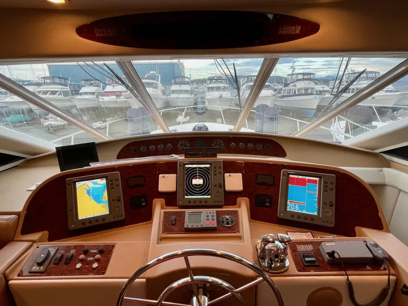 Slide: The Image of 2002 Bayliner 5788 yacht helm with electronic Cummins QSMs, marina view. - 29