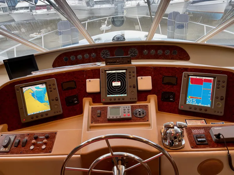 Slide: The Image of 2002 Bayliner 5788 helm with electronic Cummins QSMs, featuring advanced navigation systems. - 30