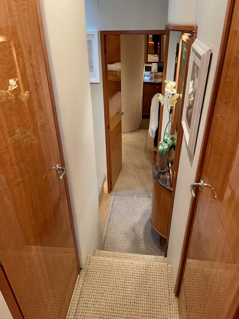 Slide: The Image of Interior hallway of 2002 Bayliner 5788 yacht with wooden doors and carpeted floor. - 39