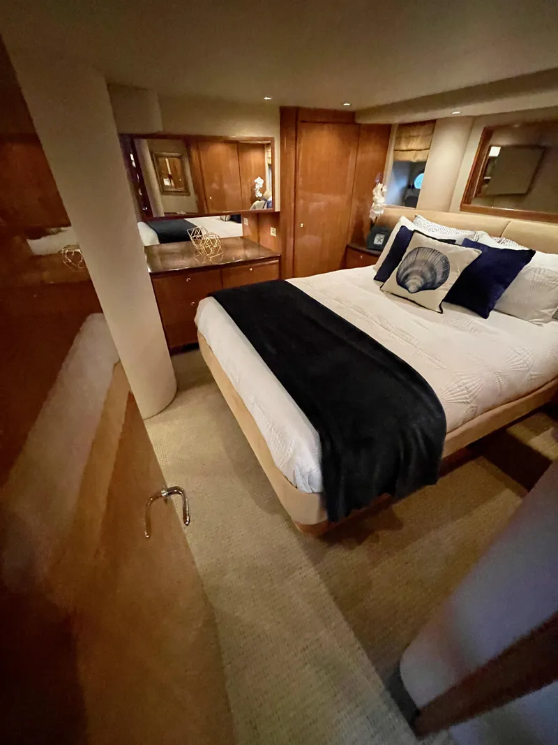 Slide: The Image of Luxurious bedroom in a 2002 Bayliner 5788 yacht with elegant wood finishes. - 40