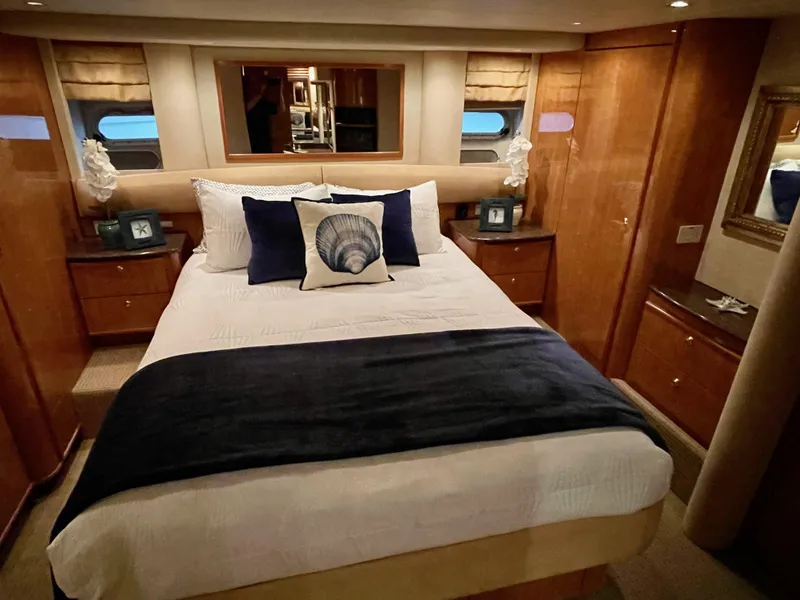 Slide: The Image of Luxurious bedroom in a 2002 Bayliner 5788 yacht with elegant decor and cozy bedding. - 42