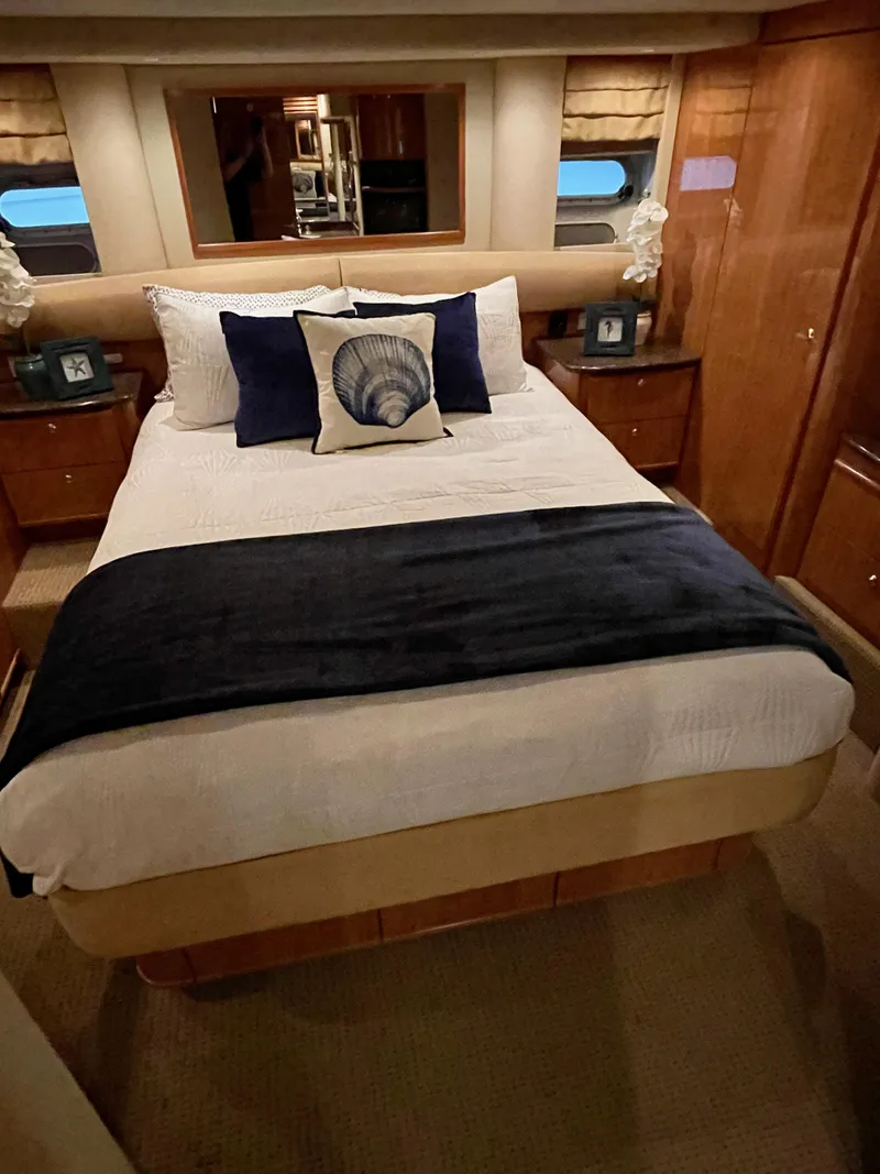 Slide: The Image of Luxurious bedroom in a 2002 Bayliner 5788 yacht with elegant decor. - 44
