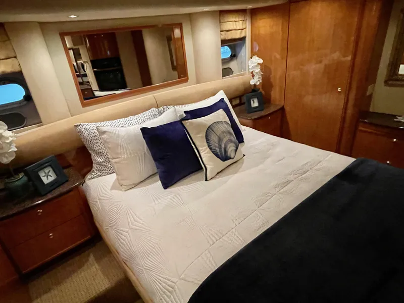 Slide: The Image of Luxurious bedroom in a 2002 Bayliner 5788 yacht with elegant decor and comfortable bedding. - 46