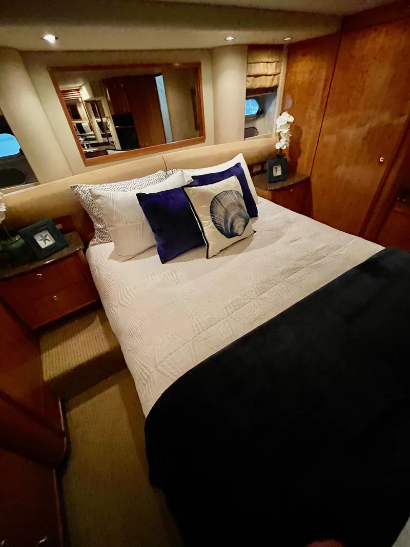 Slide: The Image of Luxurious bedroom in 2002 Bayliner 5788 yacht with elegant decor and comfortable bedding. - 47