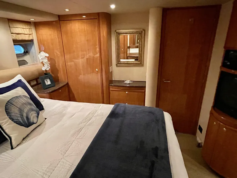 Slide: The Image of Luxurious bedroom interior of 2002 Bayliner 5788 yacht with elegant wood finishes. - 49