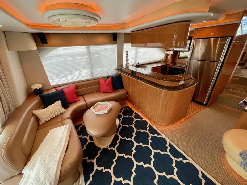 Slide: The Image of Luxurious interior of 2002 Bayliner 5788 yacht with modern kitchen and cozy seating area. - 5