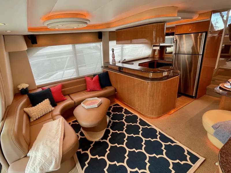 Slide: The Image of Luxurious interior of 2002 Bayliner 5788 yacht with modern kitchen and cozy seating area. - 6