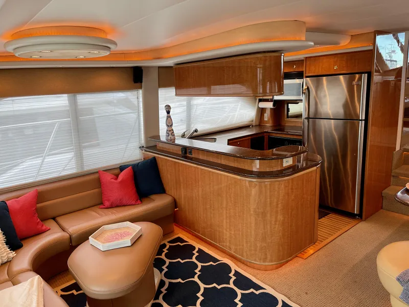 Slide: The Image of Luxurious interior of 2002 Bayliner 5788 yacht with modern kitchen and cozy seating area. - 7