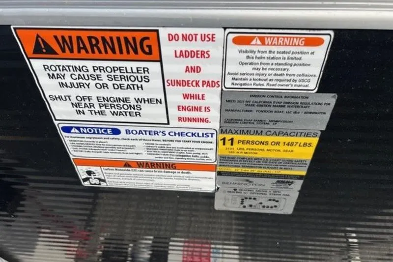 Slide: The Image of Warning labels on a 2021 Bennington 23 LSB boat, highlighting safety precautions and capacity limits. - 12