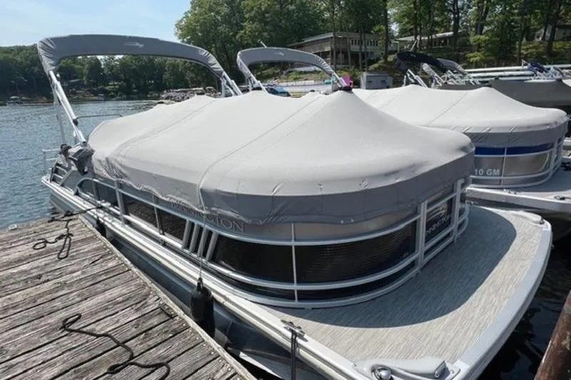 Slide: The Image of 2021 Bennington 23 LSB pontoon boat docked with cover on, sunny day. - 3