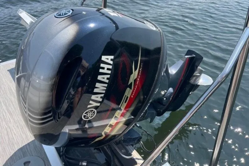 Slide: The Image of Yamaha outboard motor on 2021 Bennington 23 LSB pontoon boat, docked on water. - 4