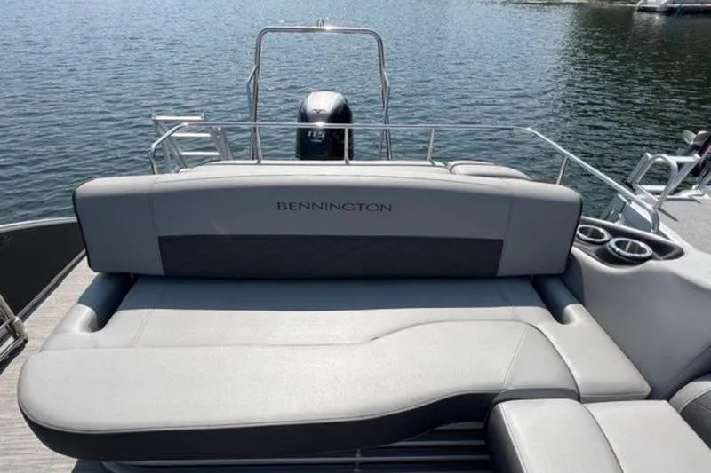 Slide: The Image of 2021 Bennington 23 LSB boat with comfortable seating on a calm lake. - 6
