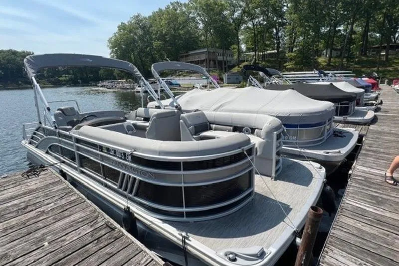 Slide: The Image of 2021 Bennington 23 LSB pontoon boat docked on a sunny day. - 8