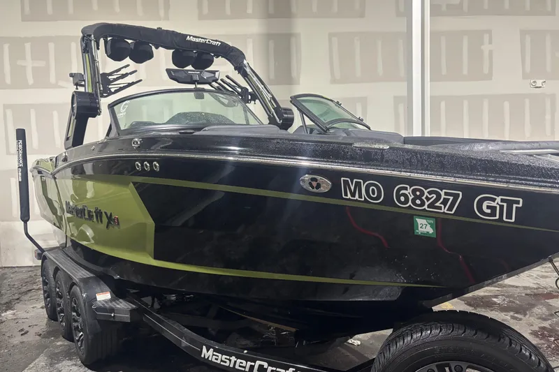 The Image of 2022 MasterCraft XStar boat on trailer in indoor setting. - 1