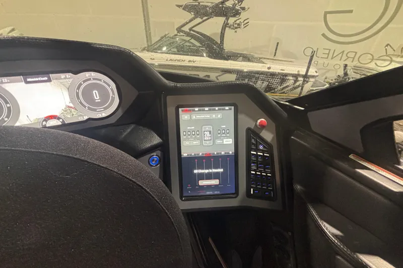 Slide: The Image of 2022 MasterCraft XStar dashboard with digital controls and steering wheel. - 14