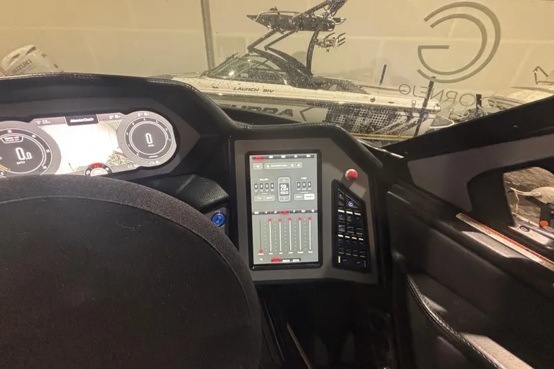 Slide: The Image of 2022 MasterCraft XStar dashboard with digital controls and steering wheel. - 15