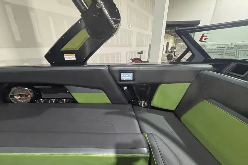 Slide: The Image of 2022 MasterCraft XStar interior with green and black seating, modern design, and audio system. - 17