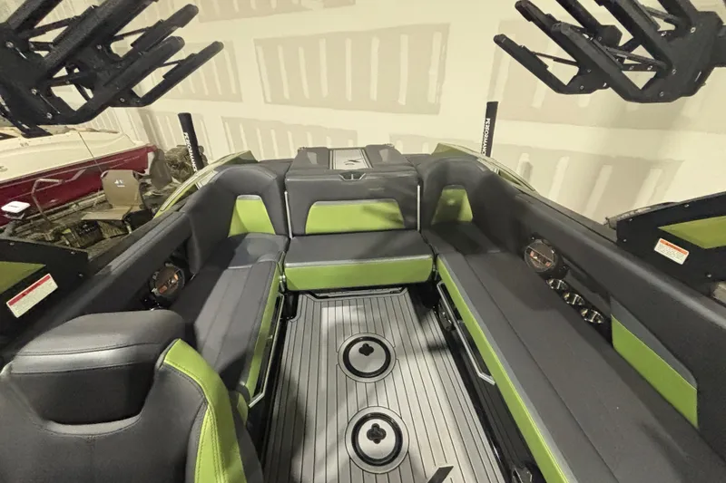Slide: The Image of 2022 MasterCraft XStar interior with green and black seating, showcasing modern design and features. - 19