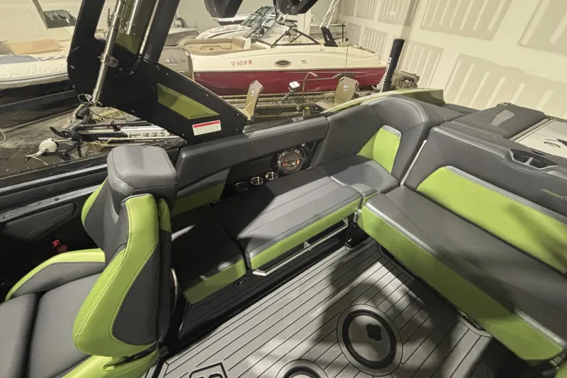 Slide: The Image of 2022 MasterCraft XStar interior with green and gray seating, showcasing modern design and comfort. - 20
