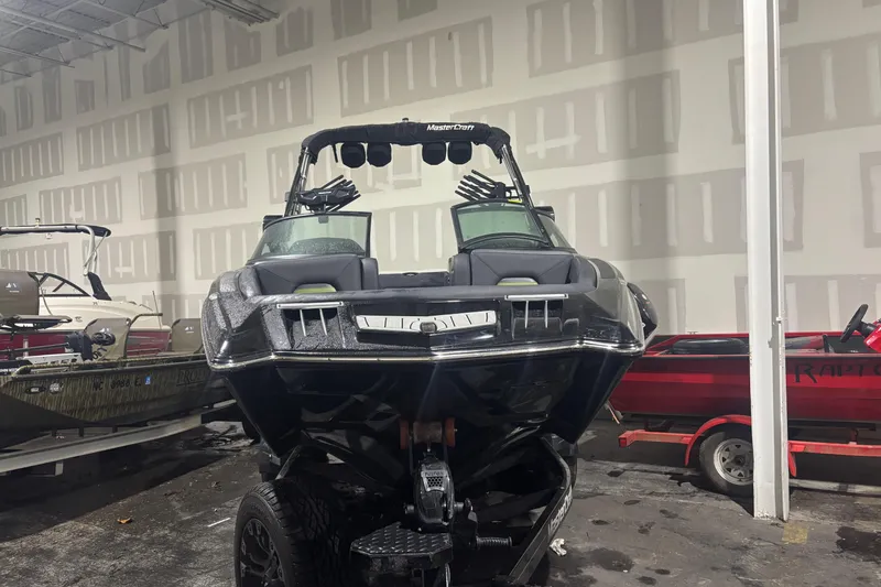 Slide: The Image of 2022 MasterCraft XStar boat in showroom, front view, sleek design. - 3
