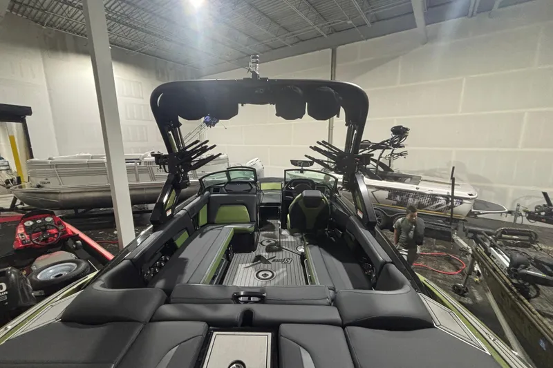 Slide: The Image of 2022 MasterCraft XStar boat interior in a showroom with modern design and seating. - 7