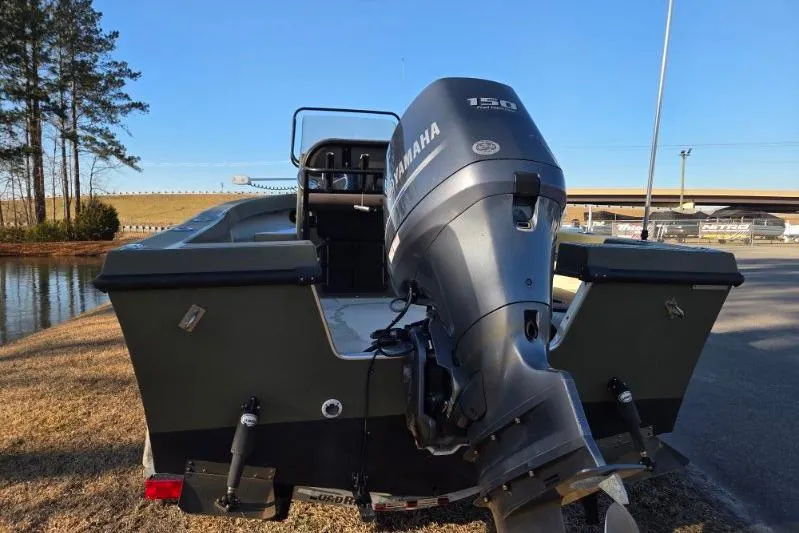 Slide: The Image of 2014 May-Craft 2000CC boat with Yamaha 150 outboard motor, parked near water. - 3