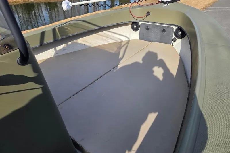 Slide: The Image of 2014 May-Craft 2000CC boat interior with shadow, near water. - 6