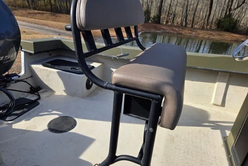 Slide: The Image of 2014 May-Craft 2000CC boat interior with cushioned seating and motor view. - 9