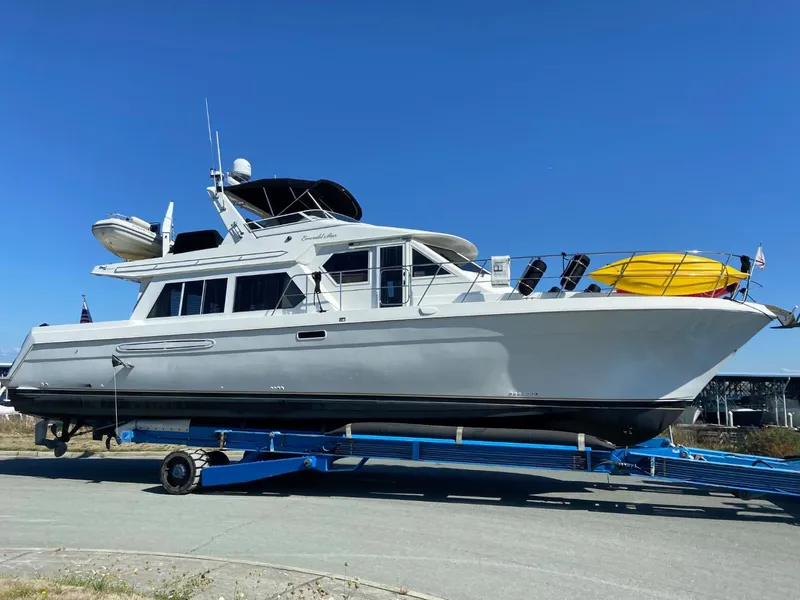 Slide: The Image of 2002 Navigator 5700 Rival yacht on trailer under clear blue sky. - 1