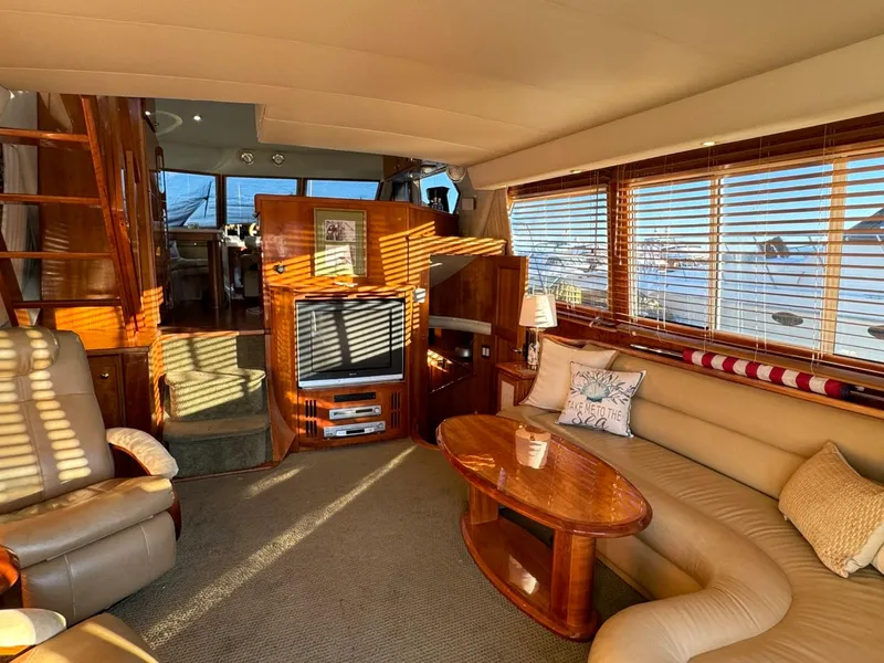 Slide: The Image of Luxurious interior of 2002 Navigator 5700 Rival yacht with cozy seating and entertainment area. - 10