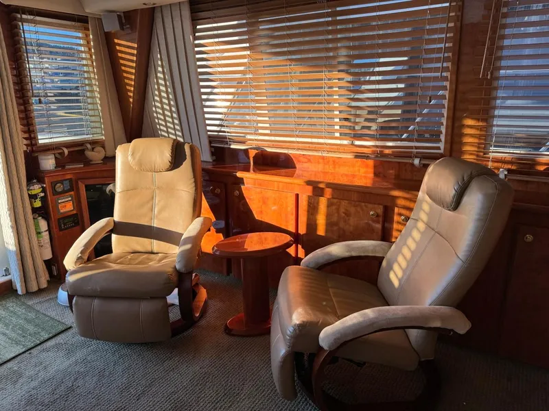 Slide: The Image of Luxurious interior of 2002 Navigator 5700 Rival yacht with leather chairs and wooden accents. - 11