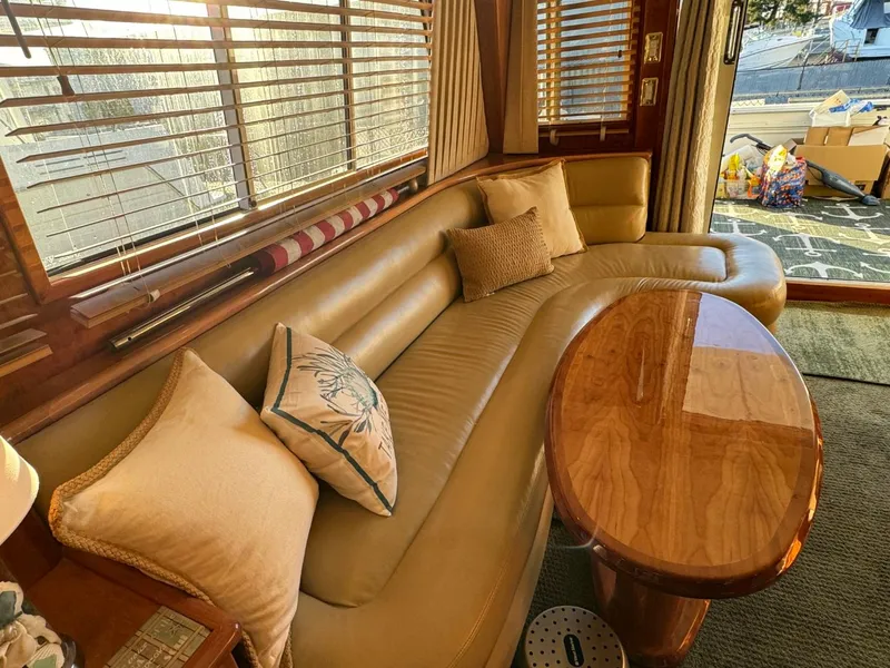 Slide: The Image of Luxurious 2002 Navigator 5700 Rival yacht interior with leather seating and wooden table. - 12
