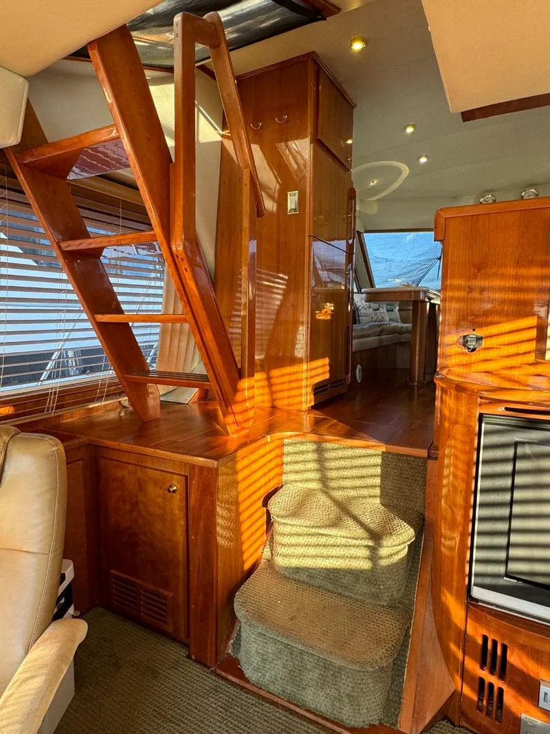 Slide: The Image of Interior of 2002 Navigator 5700 Rival yacht with wooden stairs and cozy seating area. - 13