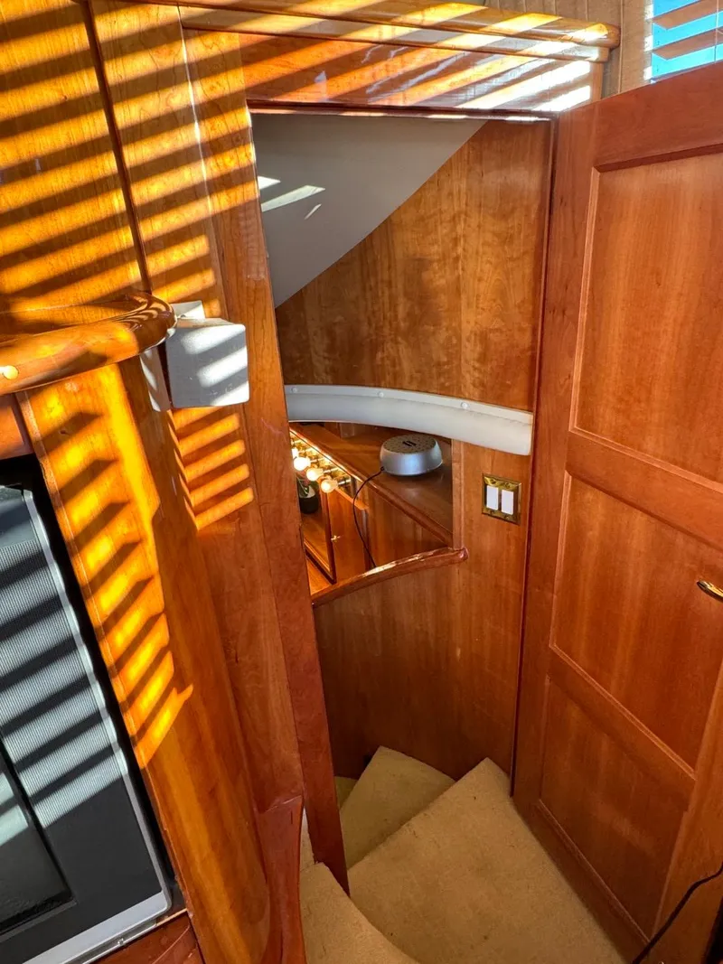 Slide: The Image of Interior of 2002 Navigator 5700 Rival yacht with wooden staircase and warm lighting. - 14