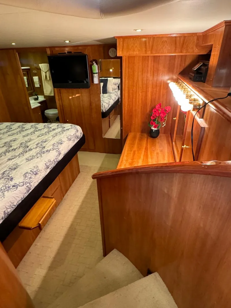 Slide: The Image of Luxurious 2002 Navigator 5700 Rival yacht interior with wood finish and cozy bedroom. - 16