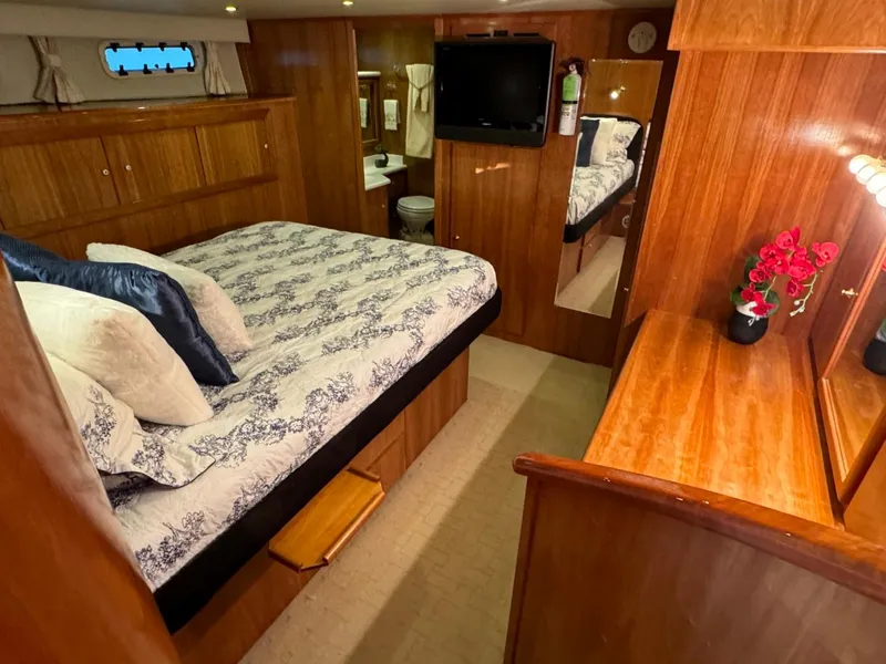 Slide: The Image of Luxurious bedroom interior of 2002 Navigator 5700 Rival yacht with wood paneling and elegant decor. - 17