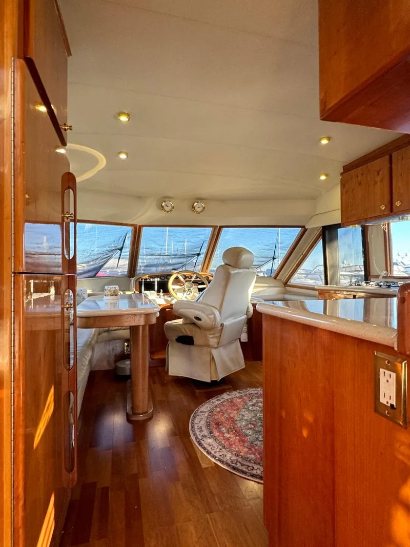 Slide: The Image of Luxurious 2002 Navigator 5700 Rival yacht interior with wood finishes and panoramic windows. - 28