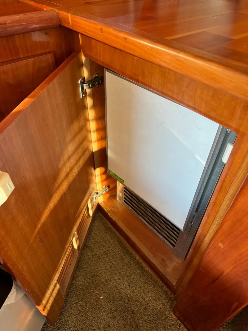 Slide: The Image of Wooden cabinet with open door revealing built-in refrigerator on 2002 Navigator 5700 Rival. - 29