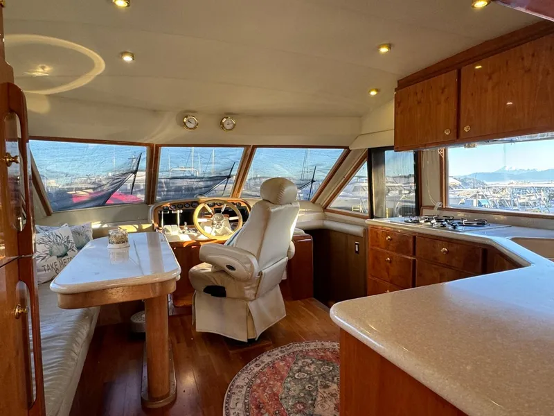 Slide: The Image of Luxurious 2002 Navigator 5700 Rival yacht interior with helm, dining area, and panoramic windows. - 31