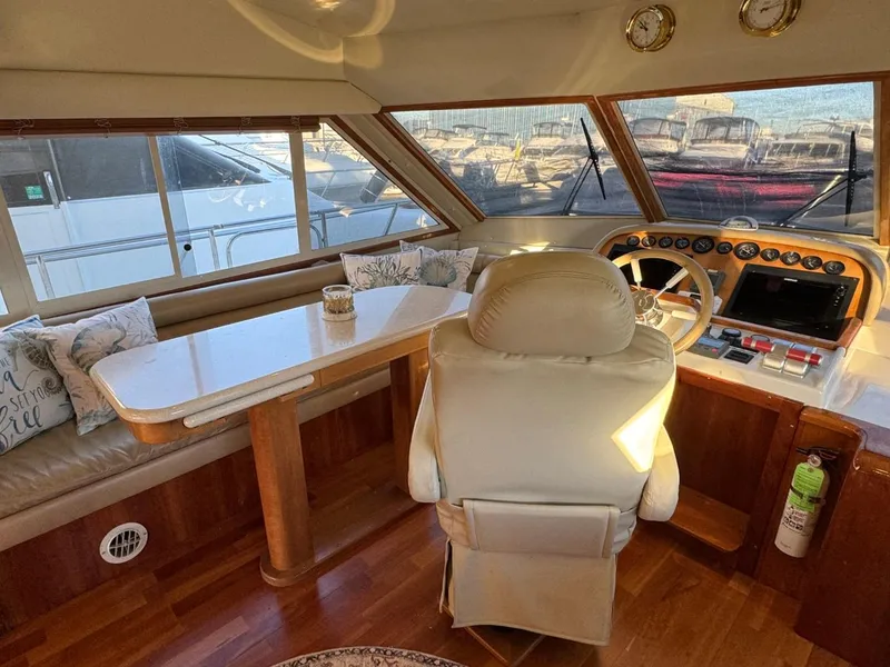 Slide: The Image of Navigator 5700 Rival 2002 yacht interior with helm, seating, and table. - 32