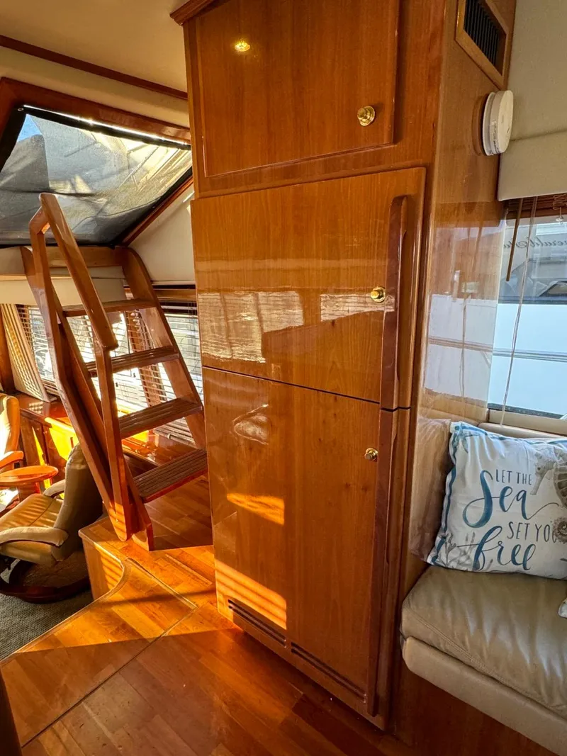 Slide: The Image of Interior of 2002 Navigator 5700 Rival yacht with wooden cabinetry and seating area. - 33