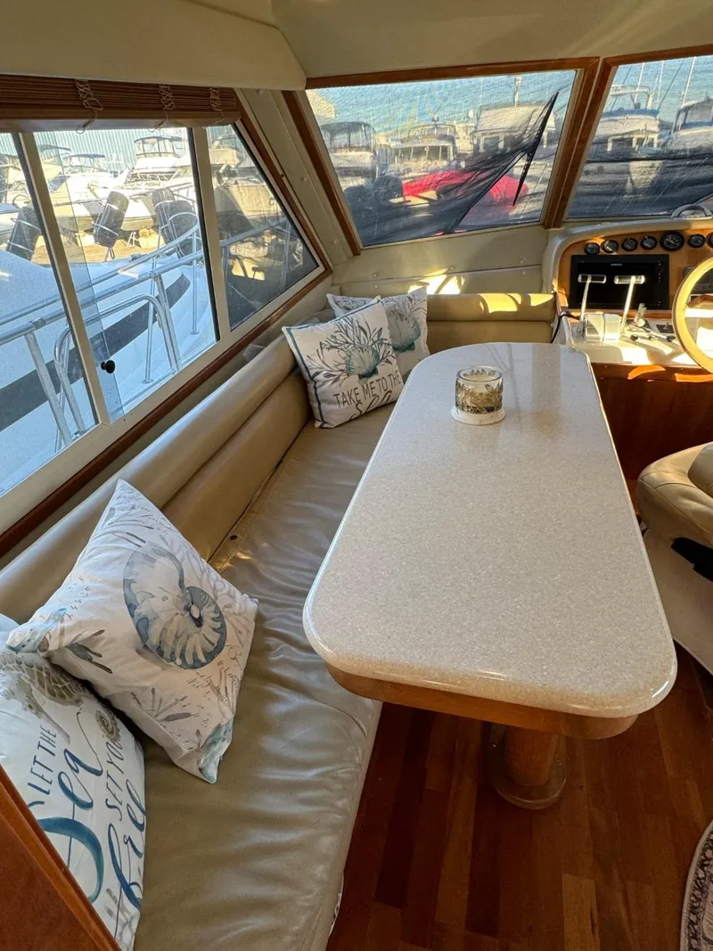 Slide: The Image of Luxurious 2002 Navigator 5700 Rival yacht interior with elegant seating and table. - 34