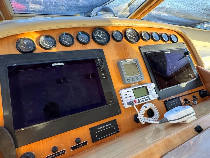 Slide: The Image of Navigator 5700 Rival 2002 boat dashboard with navigation screens and gauges. - 36