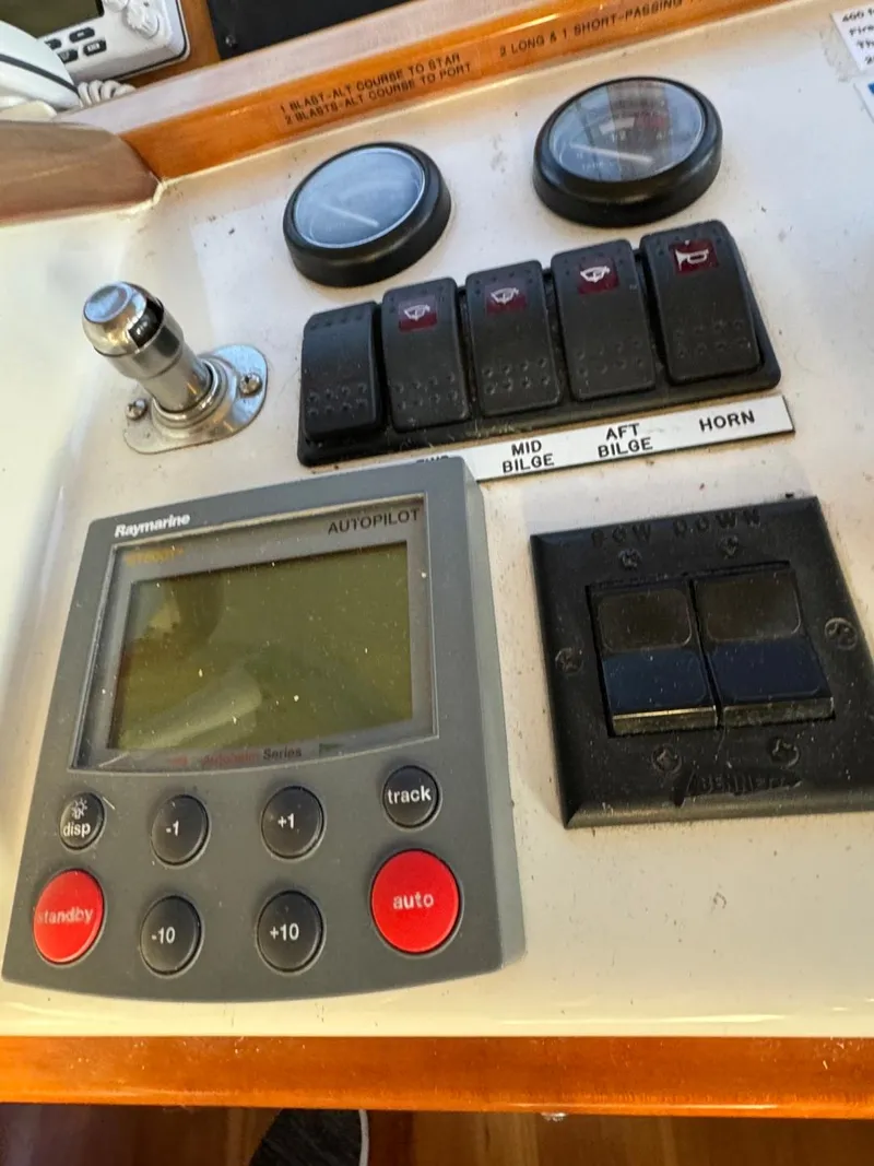 Slide: The Image of Boat control panel with Raymarine autopilot, switches, and gauges on a Navigator 5700 Rival, 2002 model. - 39