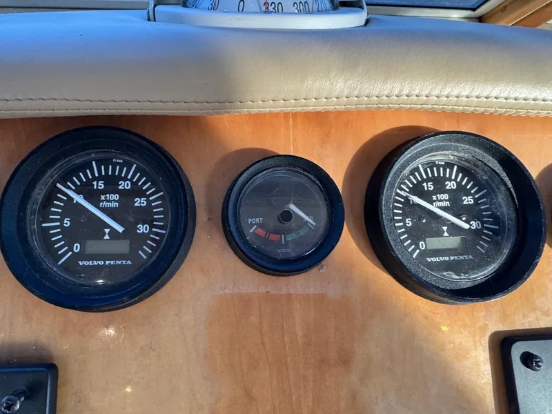 Slide: The Image of Dashboard gauges of 2002 Navigator 5700 Rival boat, featuring Volvo Penta instruments. - 40