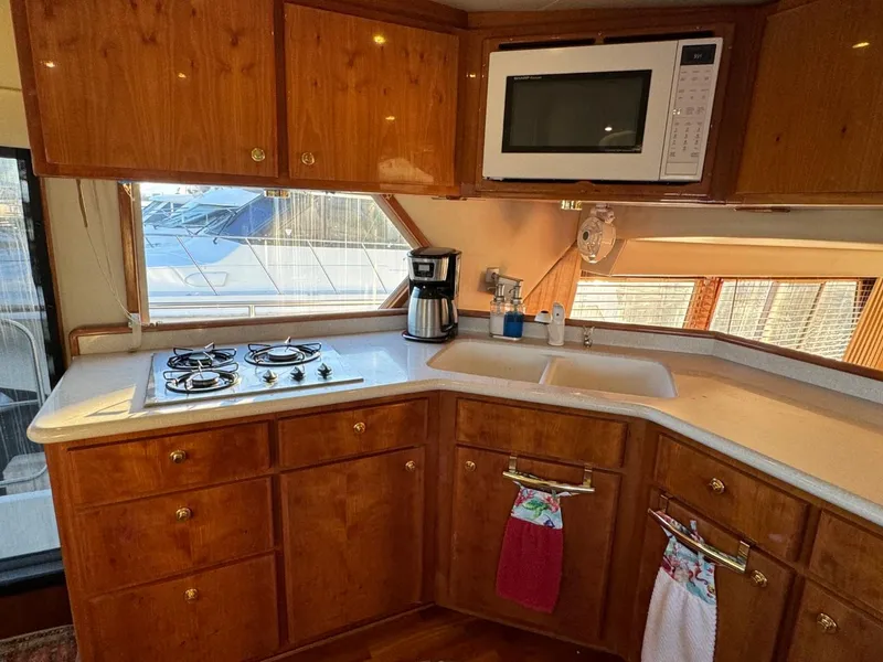 Slide: The Image of Navigator 5700 Rival 2002 yacht kitchen with stove, microwave, and coffee maker. - 44