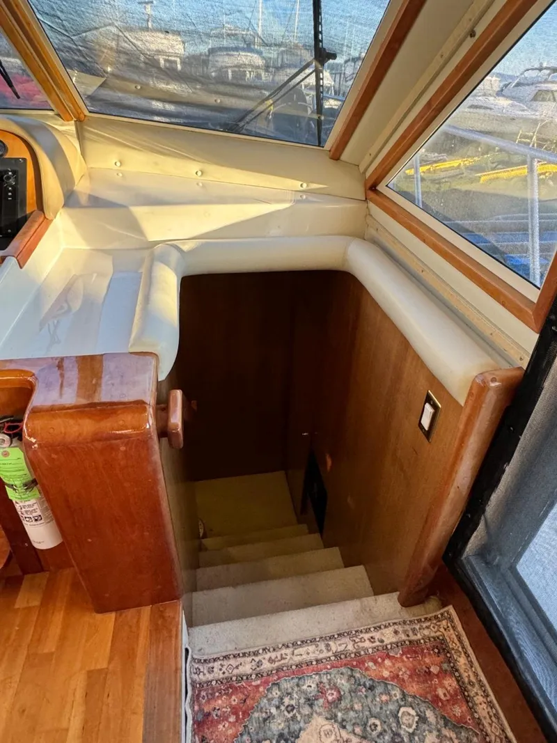 Slide: The Image of Interior view of 2002 Navigator 5700 Rival yacht with wooden stairs and carpet. - 48